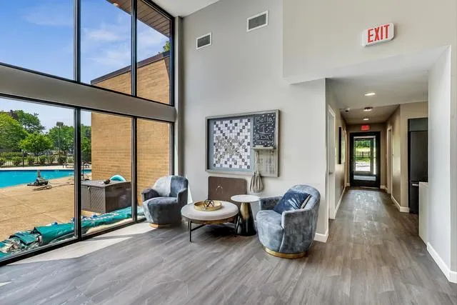 a view of a house with pool and chairs