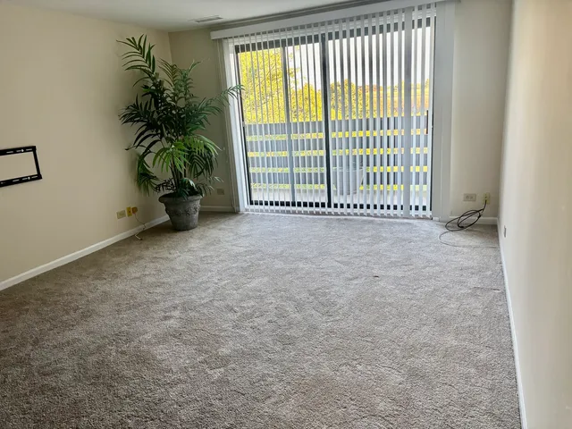a view of an empty room with a balcony