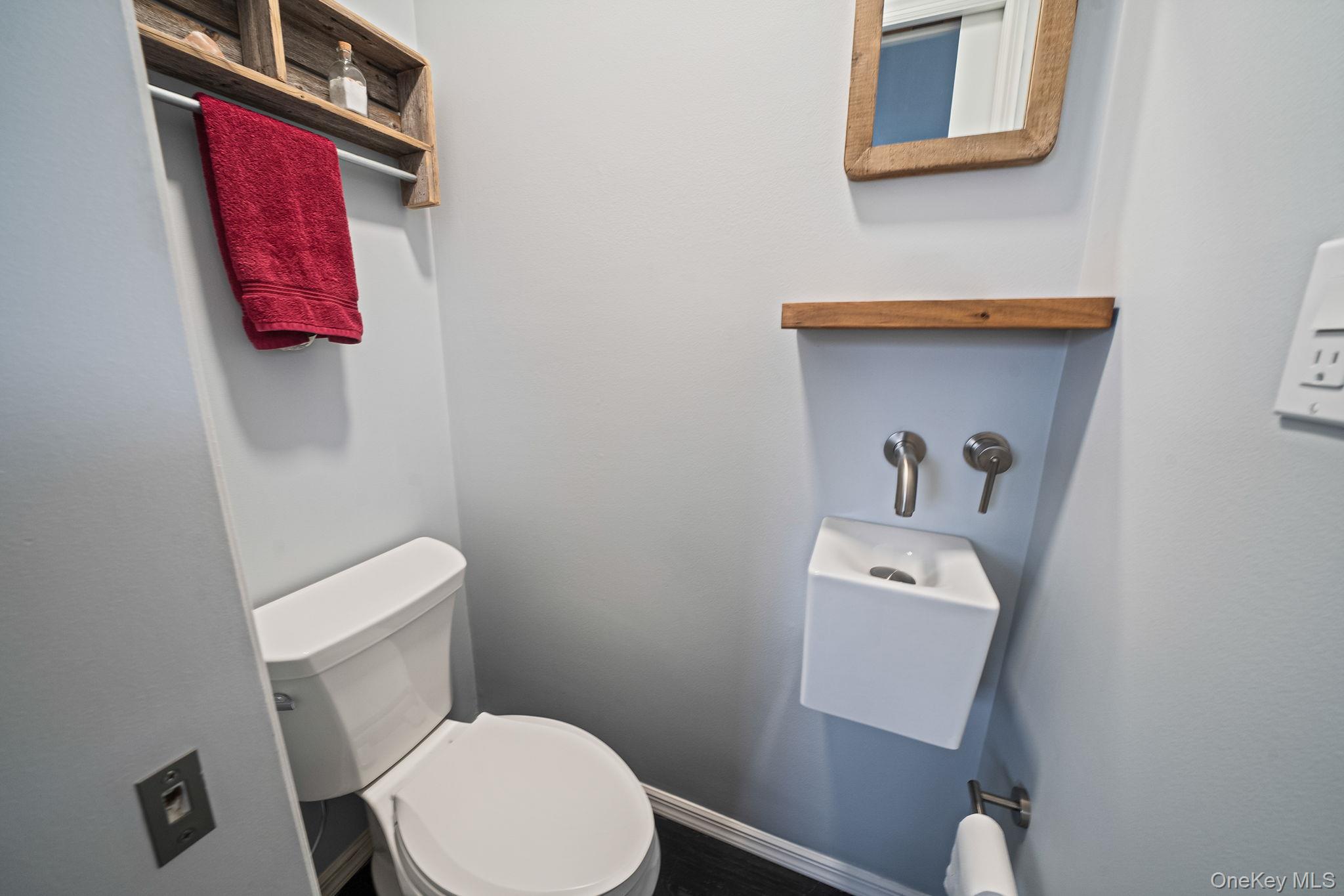 110 Stephen Road Bayport, NY 11705 - Photo 34 of 39 a white toilet sitting next to a bathroom sink