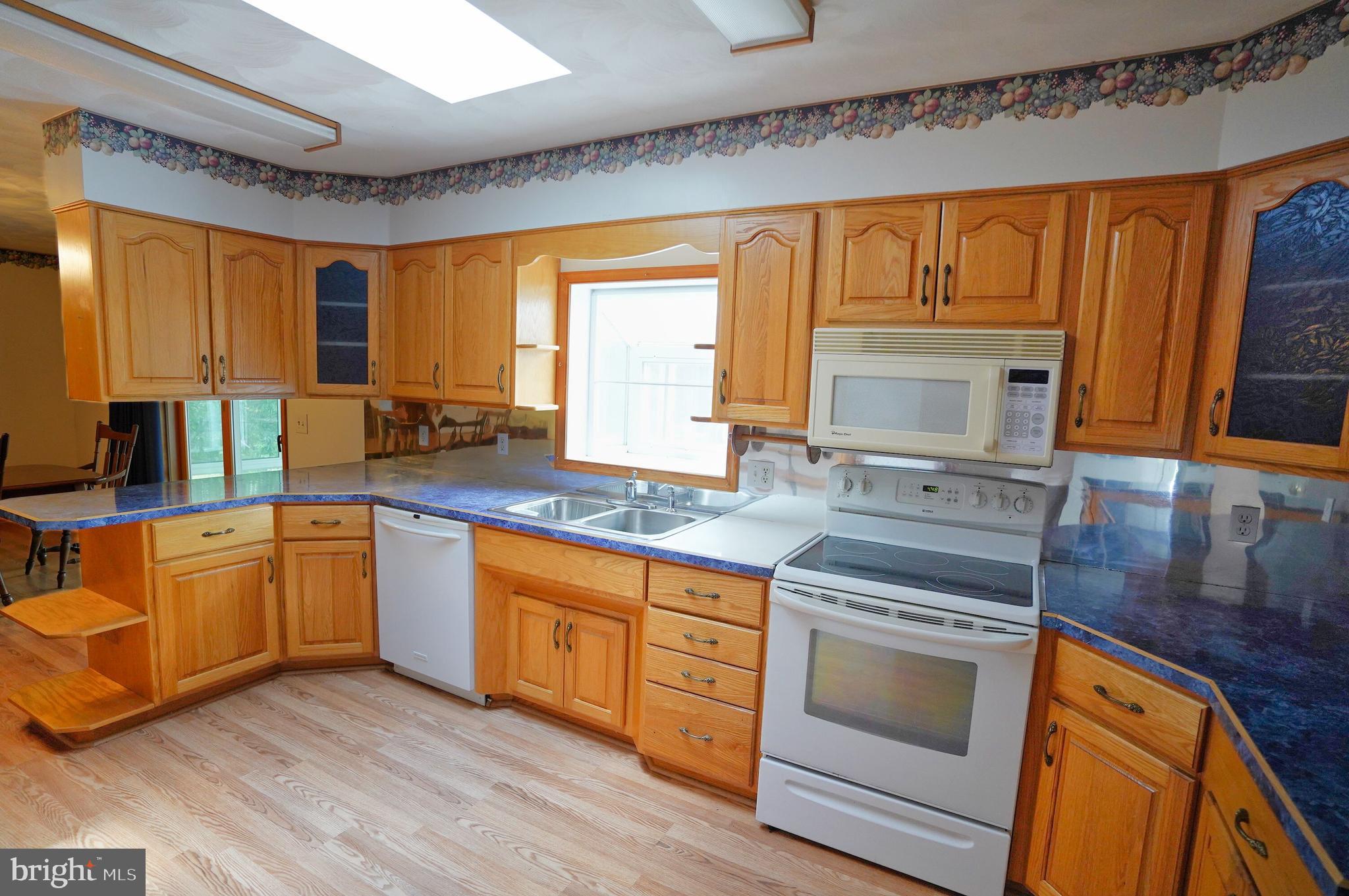 775 East Berlin Road York Springs, PA 17372 - Photo 8 of 33 a kitchen with stainless steel appliances granite countertop a stove a sink and a microwave