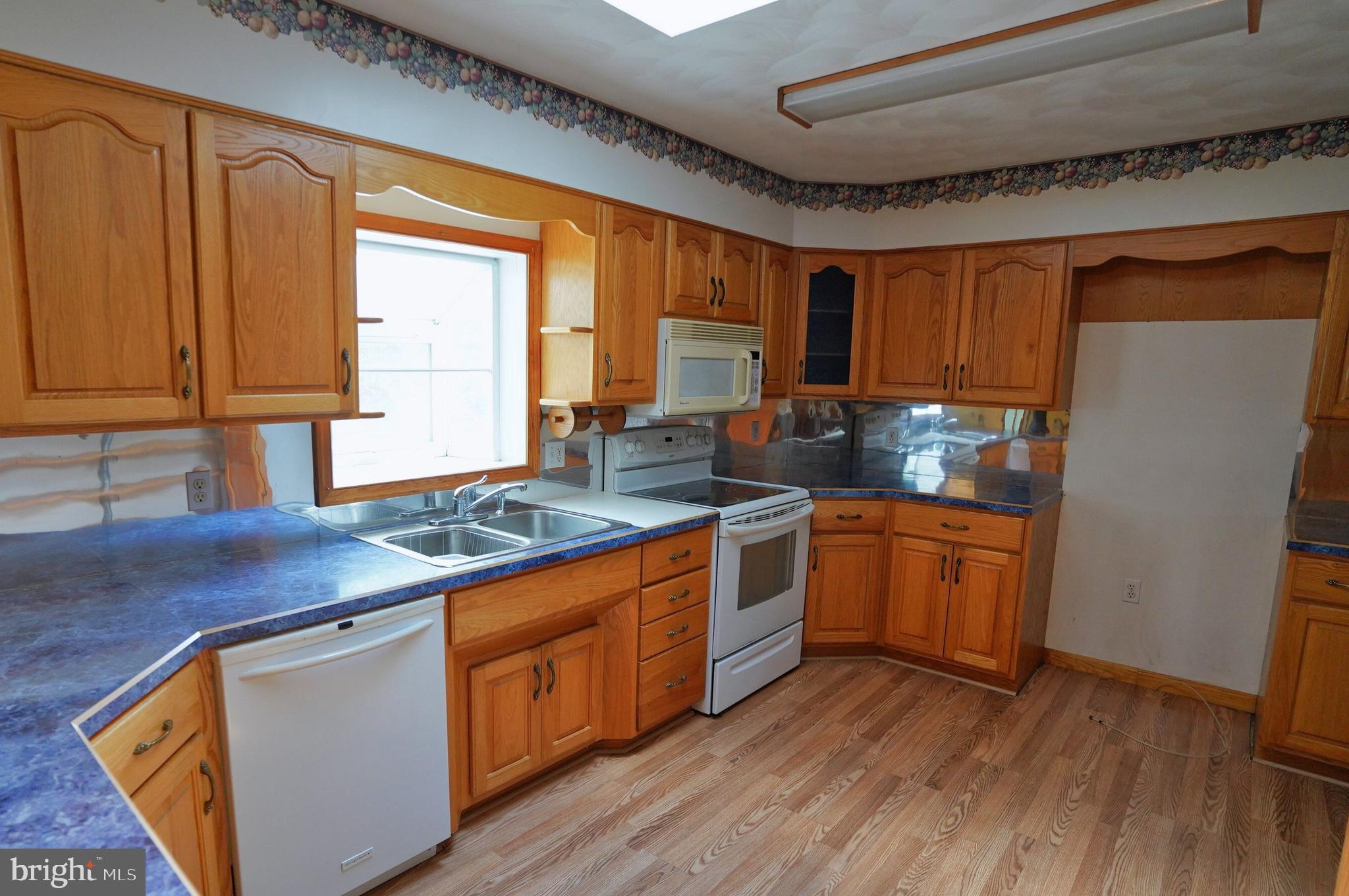 775 East Berlin Road York Springs, PA 17372 - Photo 9 of 33 a kitchen with stainless steel appliances granite countertop wooden cabinets a sink and a granite counter tops with a large window