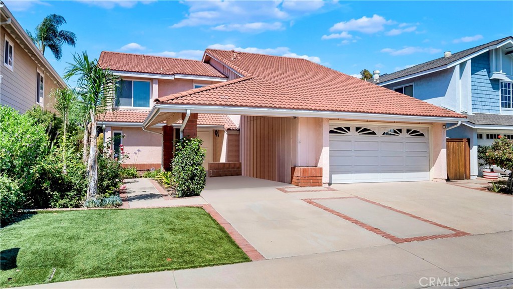9 Blue Ridge Irvine, CA 92620 - Photo 1 of 1 a front view of a house with a yard and garage