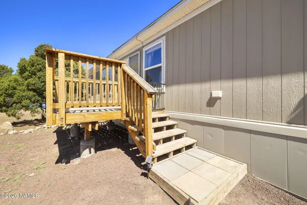 a view of balcony with wooden floor and fence