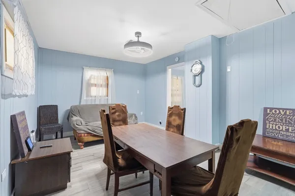 a view of a dining room with furniture window and wooden floor