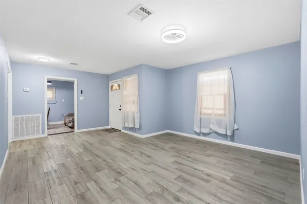 wooden floor in an empty room with a window