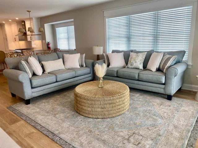 a living room with furniture and a lamp