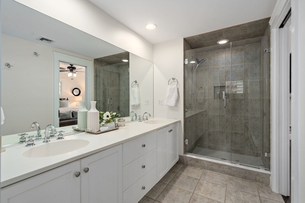 24 Tower Avenue Needham, MA 02494 - Photo 27 of 38 a bathroom with a shower sink double and mirror