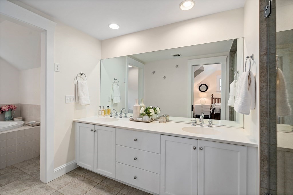 24 Tower Avenue Needham, MA 02494 - Photo 28 of 38 a bathroom with a double vanity sink and mirror