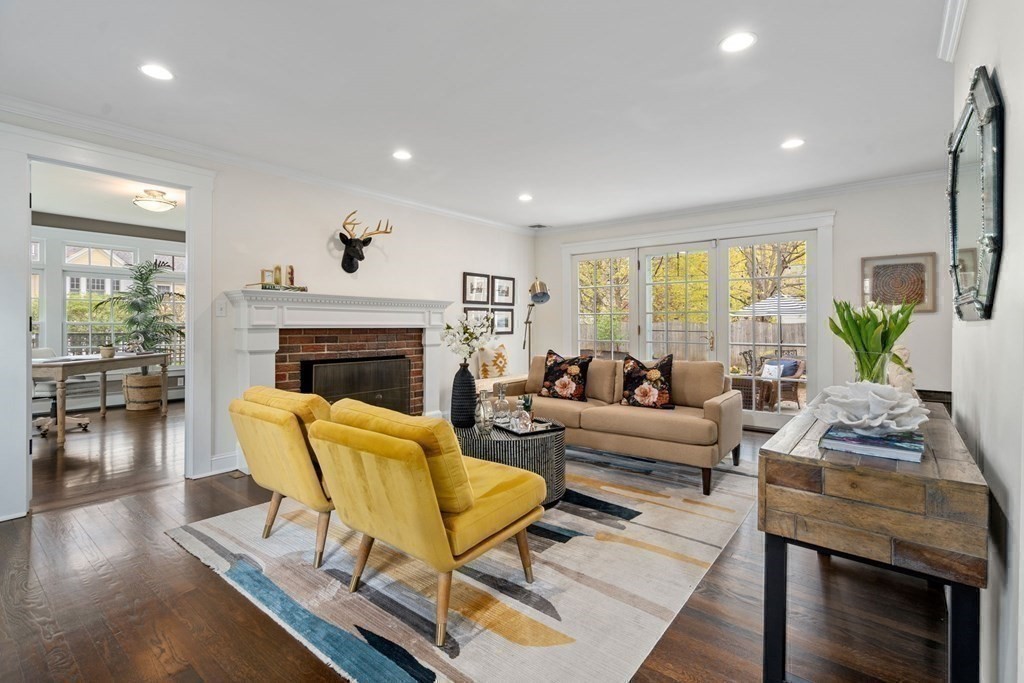24 Tower Avenue Needham, MA 02494 - Photo 7 of 38 a living room with furniture a fireplace a flat screen tv and a large window