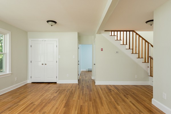 76 A First Parish Road Scituate, MA 02066 - Photo 4 of 26 a view of a hallway with wooden floor and staircase
