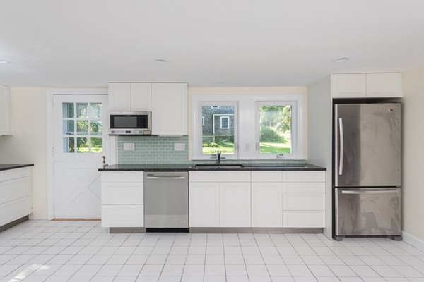 76 A First Parish Road Scituate, MA 02066 - Photo 9 of 26 a kitchen with stainless steel appliances a refrigerator sink and microwave