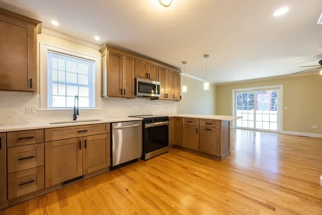 a kitchen with stainless steel appliances a refrigerator sink and cabinets