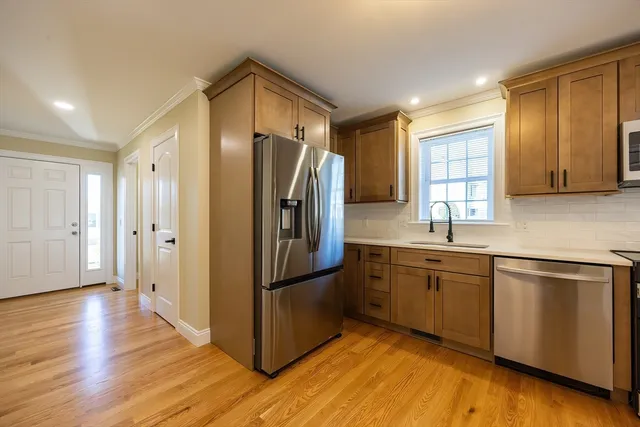 a kitchen with stainless steel appliances granite countertop a refrigerator stove microwave and sink