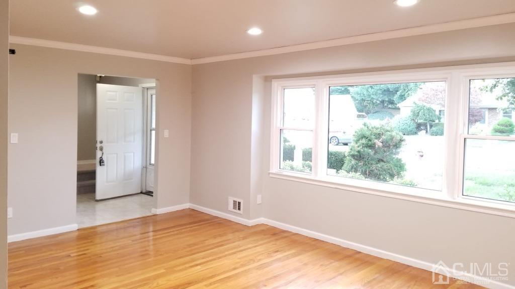 47 Brookside Road Edison, NJ 08817 - Photo 8 of 36 a view of empty room with wooden floor and fan