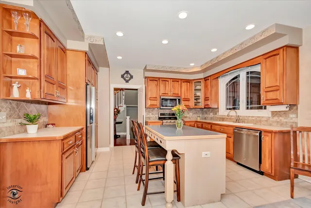 a kitchen with stainless steel appliances granite countertop a stove and cabinets