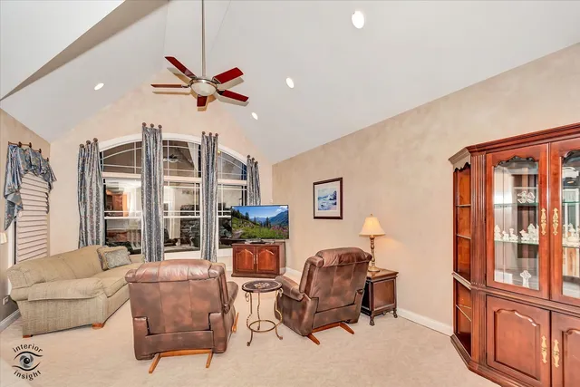 a living room with furniture a ceiling fan and a window