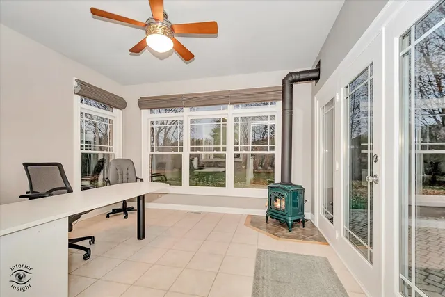 a view of a workspace with furniture and a window