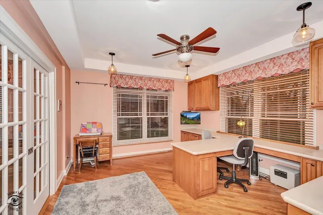 a view of a kitchen with kitchen island stainless steel appliances wooden floor and a table