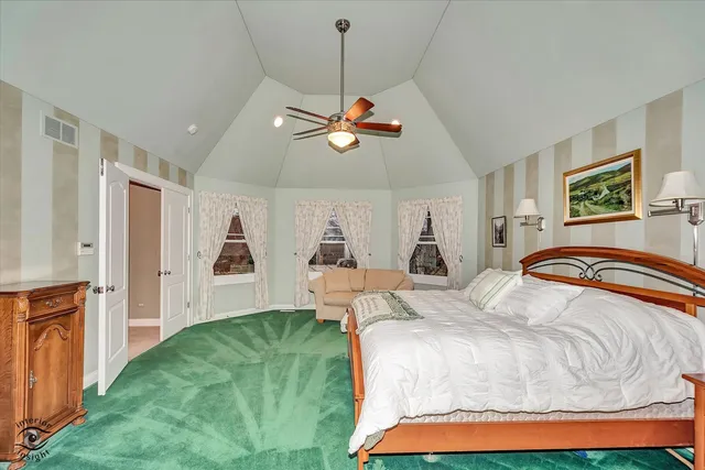 a hall with stainless steel appliances granite countertop a refrigerator and a stove top oven