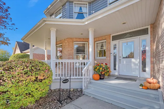 a front view of a house with outdoor seating