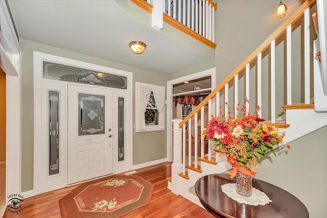 a vase of flowers sitting on a floor next to a window
