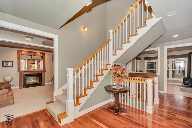 a view of entryway and hall with wooden floor