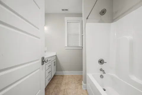 a bathroom with a bathtub and shower