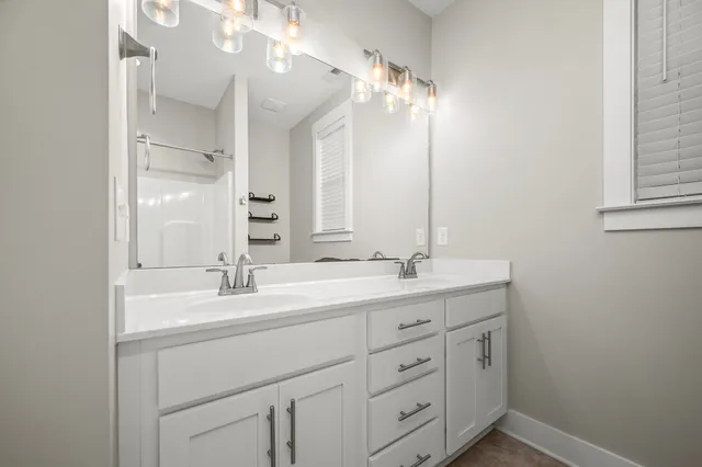 a bathroom with a double vanity sink mirror and double