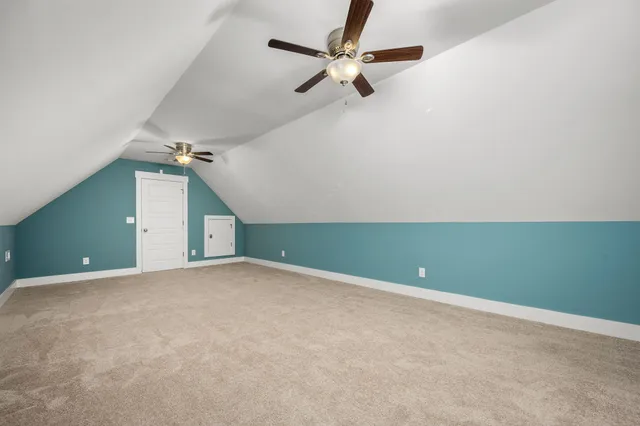 an empty room with a ceiling fan and a window