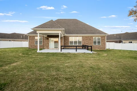 a view of a house with backyard and porch