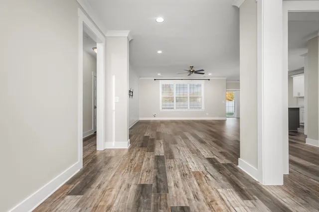 a view of a room with wooden floor and a window