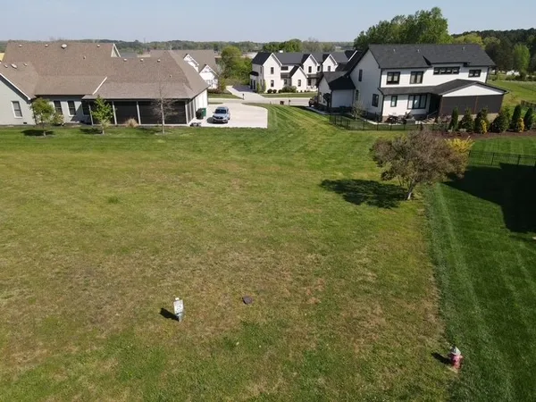 a aerial view of a house with yard