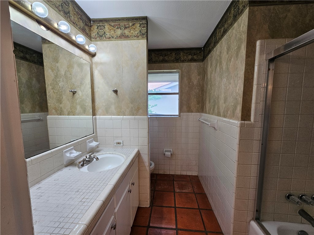4825 Wooldridge Road Corpus Christi, TX 78413 - Photo 15 of 20 a bathroom with a granite countertop sink toilet and shower
