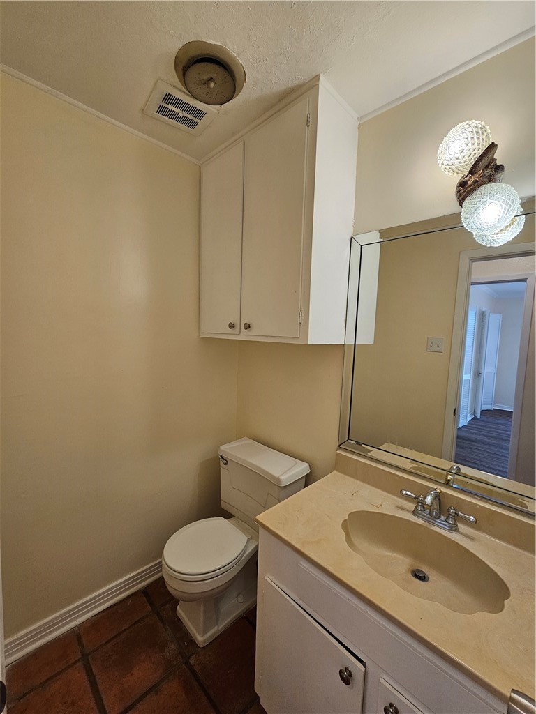 4825 Wooldridge Road Corpus Christi, TX 78413 - Photo 18 of 20 a bathroom with a granite countertop toilet sink and mirror