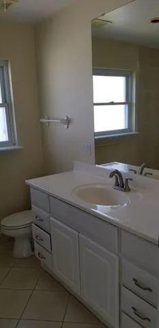 a bathroom with a toilet sink and window
