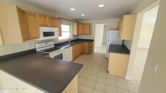 a kitchen with stainless steel appliances a refrigerator sink and microwave