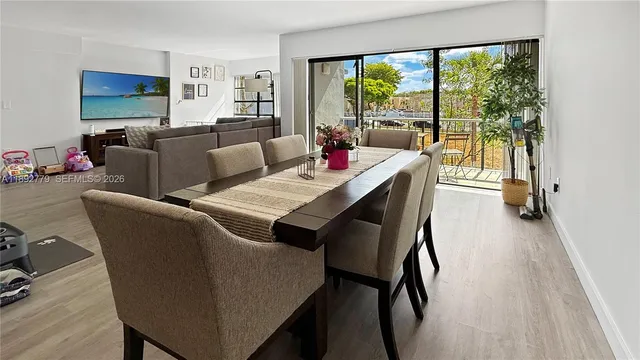 a living room with furniture a large window and a flat screen tv