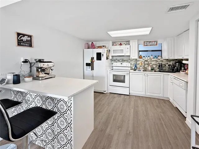 a kitchen with a sink a stove and cabinets