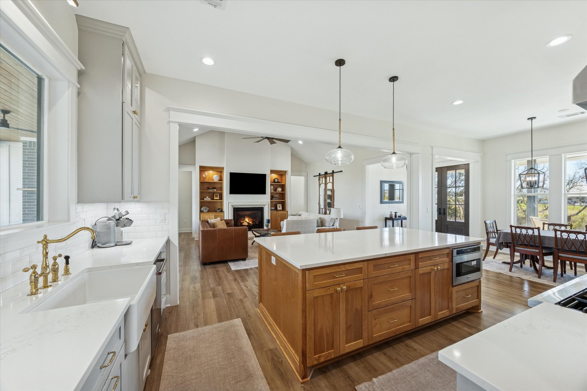 1009 Century Terrace Brenham, TX 77833 - Photo 11 of 49 a large room with kitchen island a sink stove and living room view
