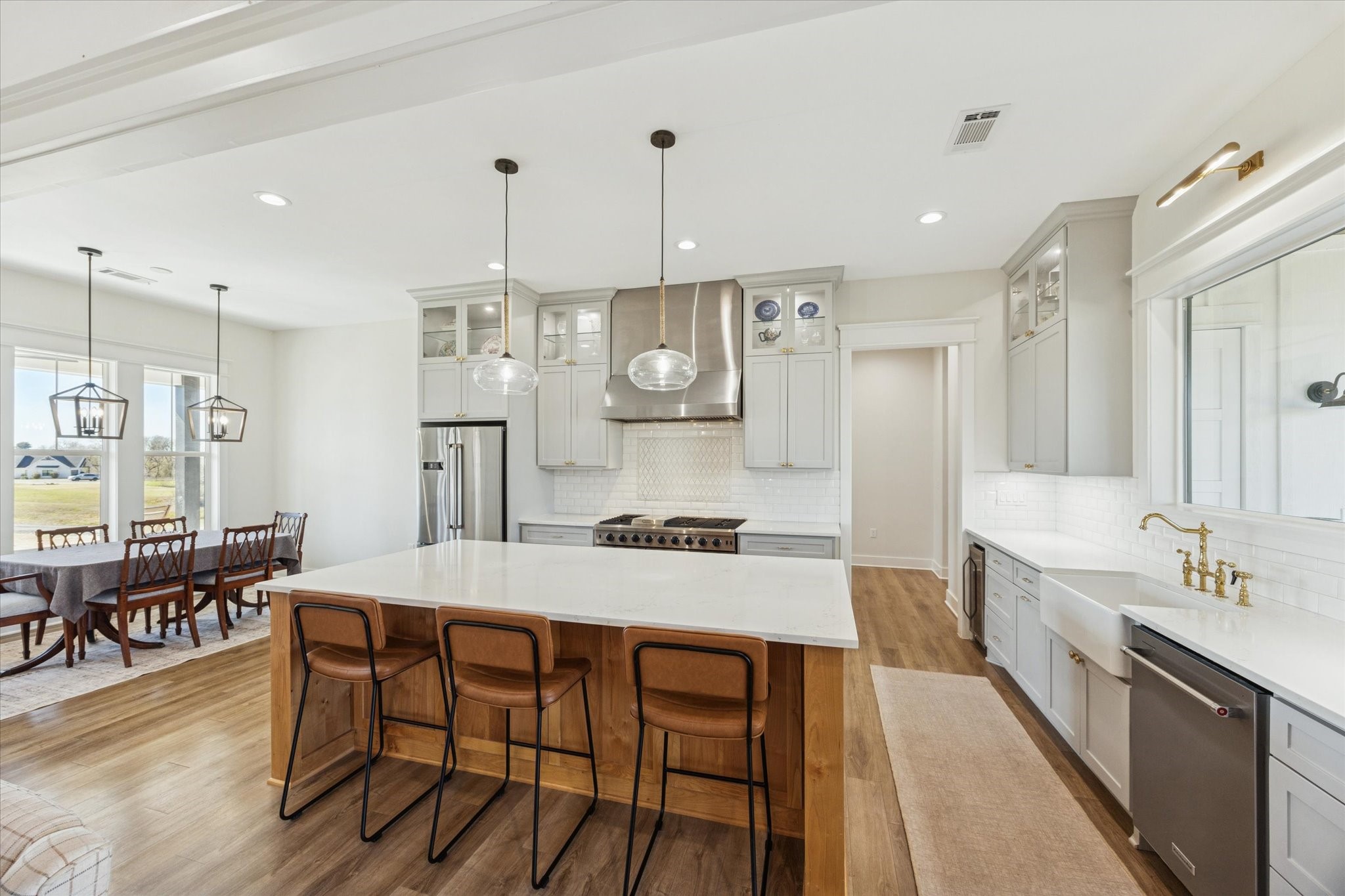 1009 Century Terrace Brenham, TX 77833 - Photo 12 of 49 a kitchen with stainless steel appliances granite countertop a kitchen island hardwood floor and a sink