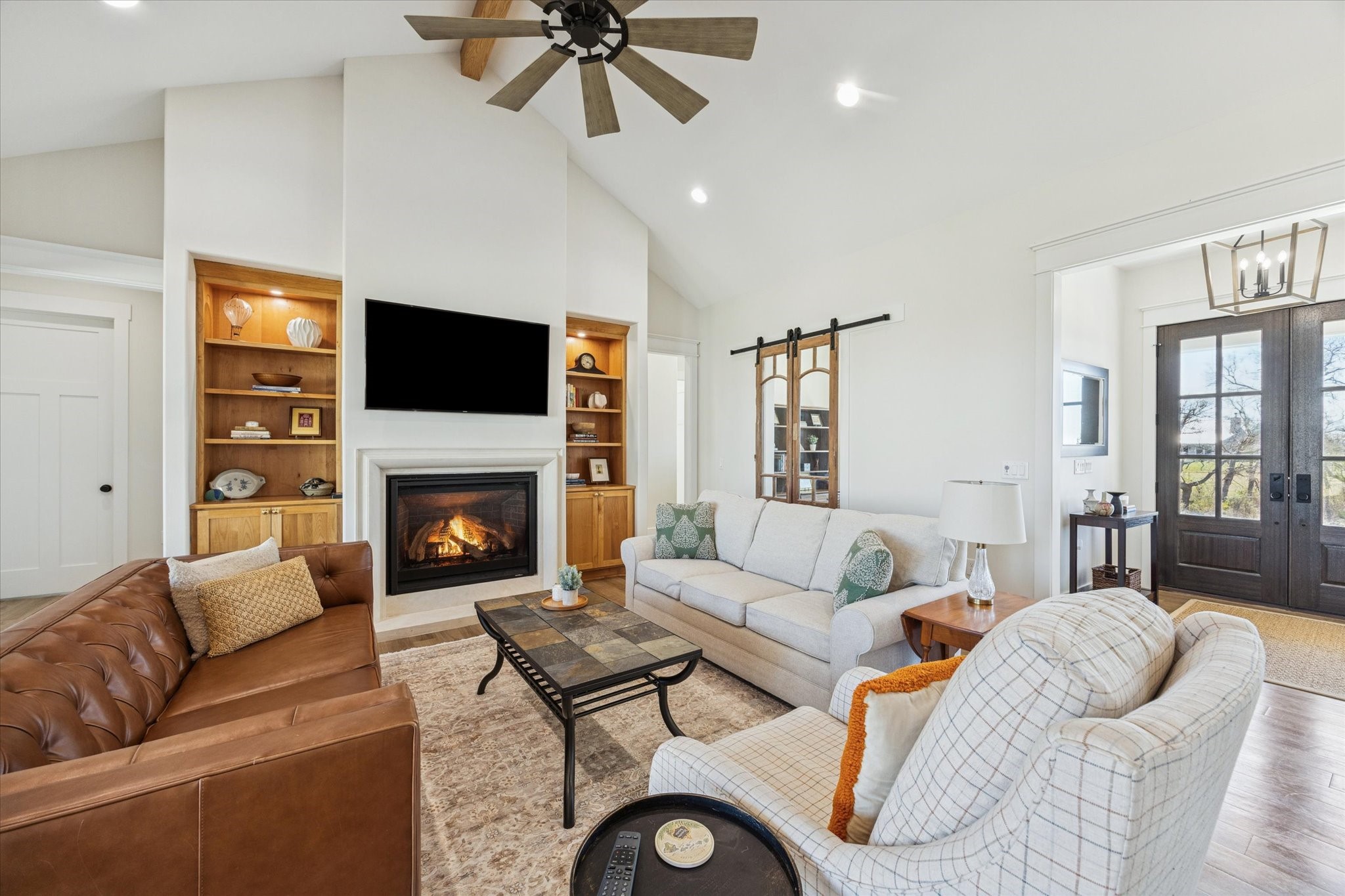 1009 Century Terrace Brenham, TX 77833 - Photo 16 of 49 a living room with furniture a fireplace and a flat screen tv