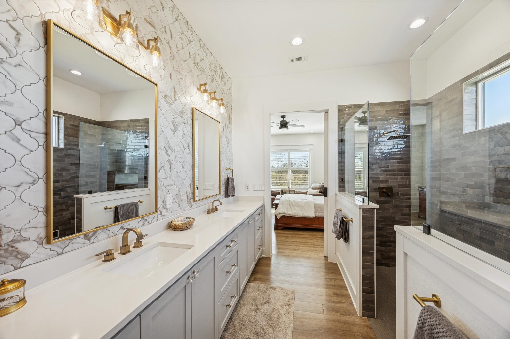 1009 Century Terrace Brenham, TX 77833 - Photo 22 of 49 a bathroom with double vanity sinks a large mirror and a shower