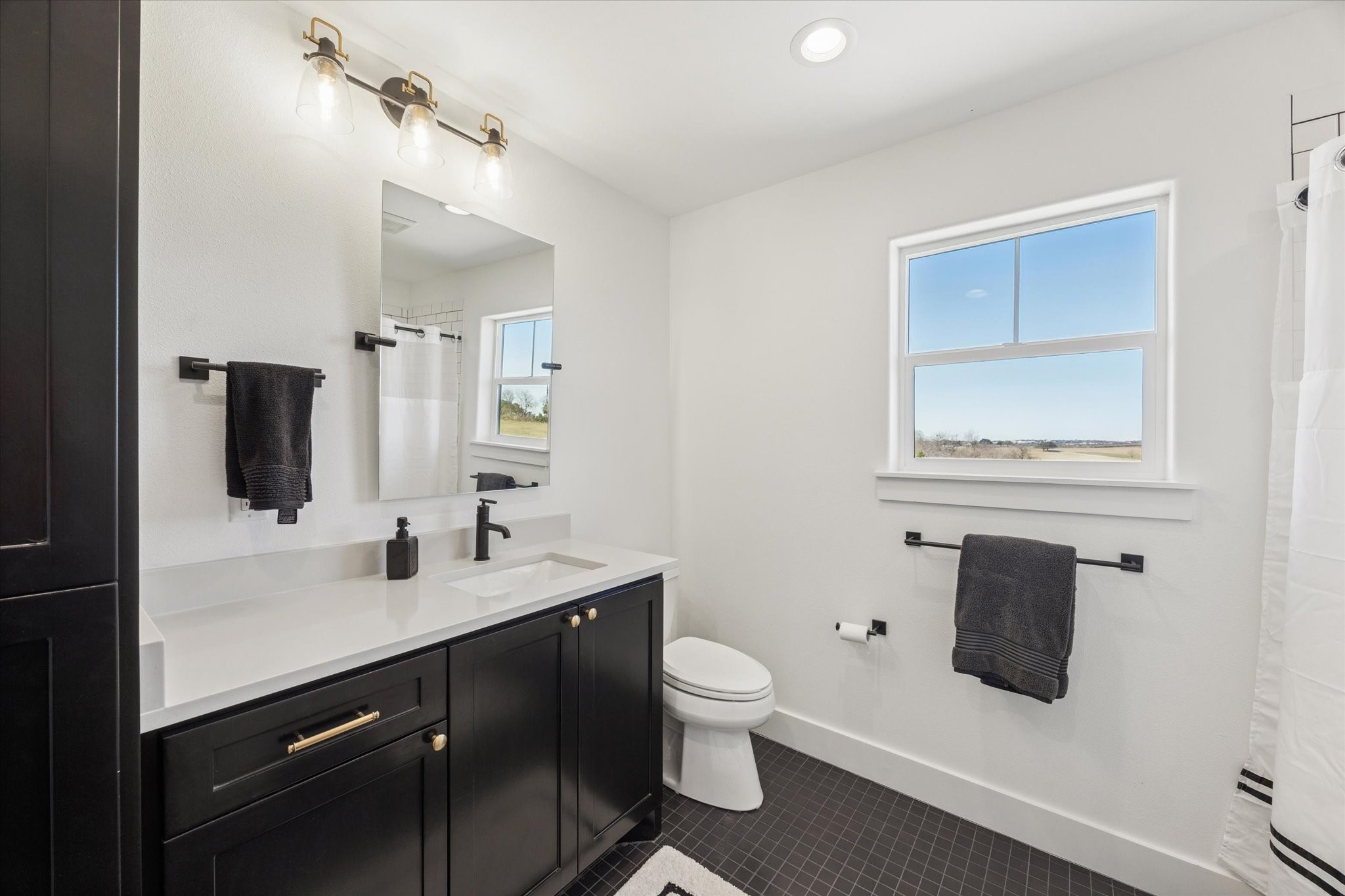 1009 Century Terrace Brenham, TX 77833 - Photo 28 of 49 a bathroom with a toilet sink and mirror