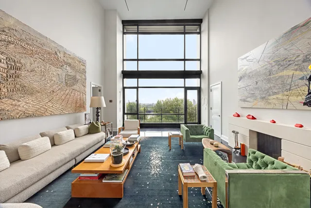 a living room with furniture and a floor to ceiling window