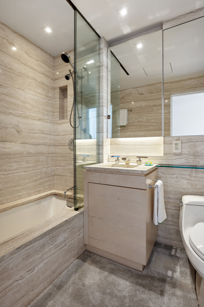 170 East End Avenue, Unit 8EF Manhattan, NY 10128 - Photo 17 of 31 a bathroom with a granite countertop sink mirror toilet and bathtub