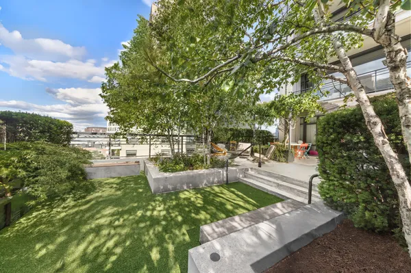 a view of a patio with couches table and chairs and potted plants