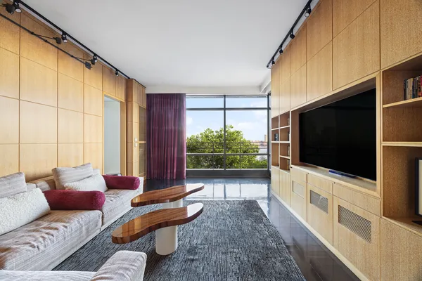 a living room with hardwood floor and a flat screen tv