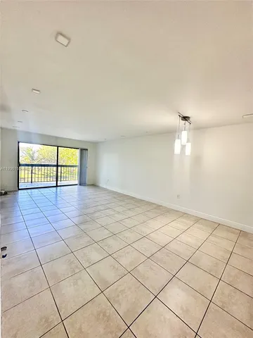 an empty room with a empty space and windows