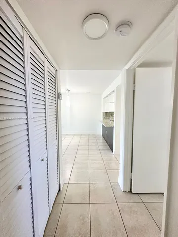 a view of a kitchen with a sink and a refrigerator