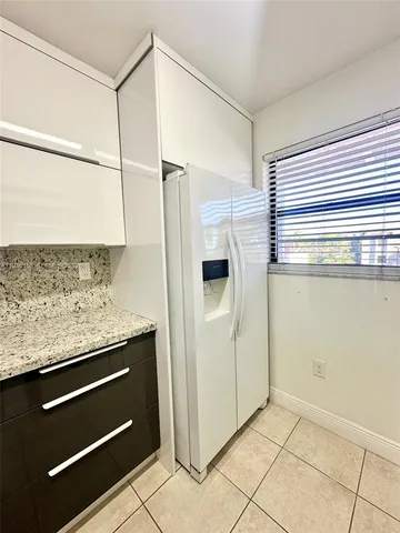 a kitchen with a refrigerator and countertop
